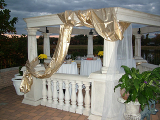  White gazebo decorated with white and gold tool.